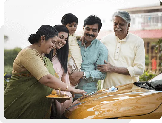 Family smiling at car purchased with TVS Credit Used Car Loans