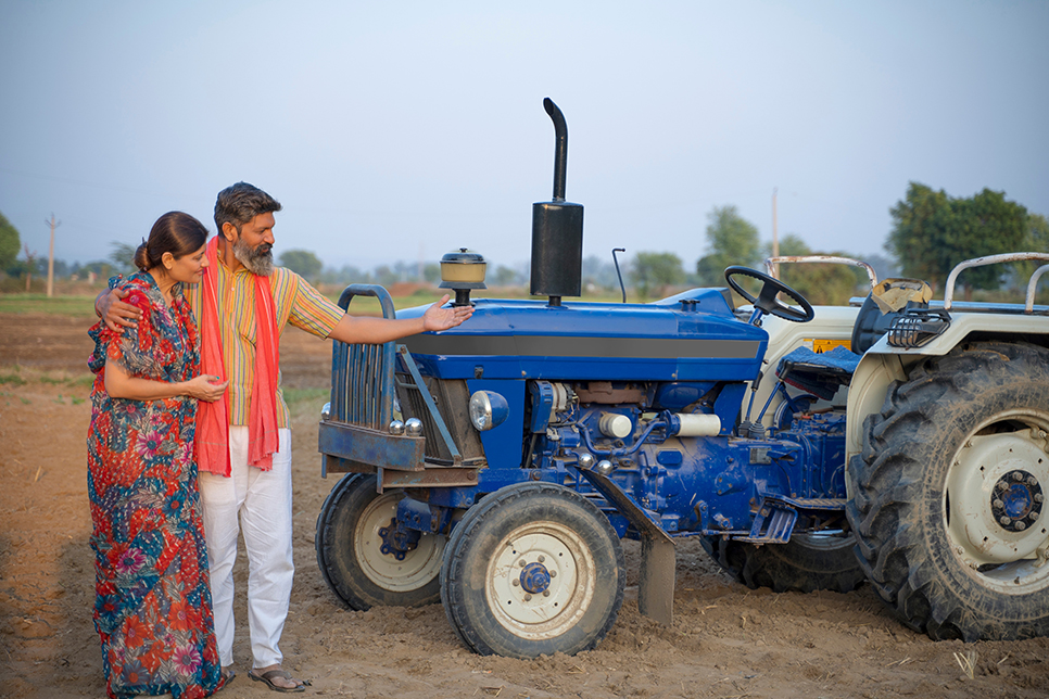 Farmer family near vehicle from NBFC Tractor Loan