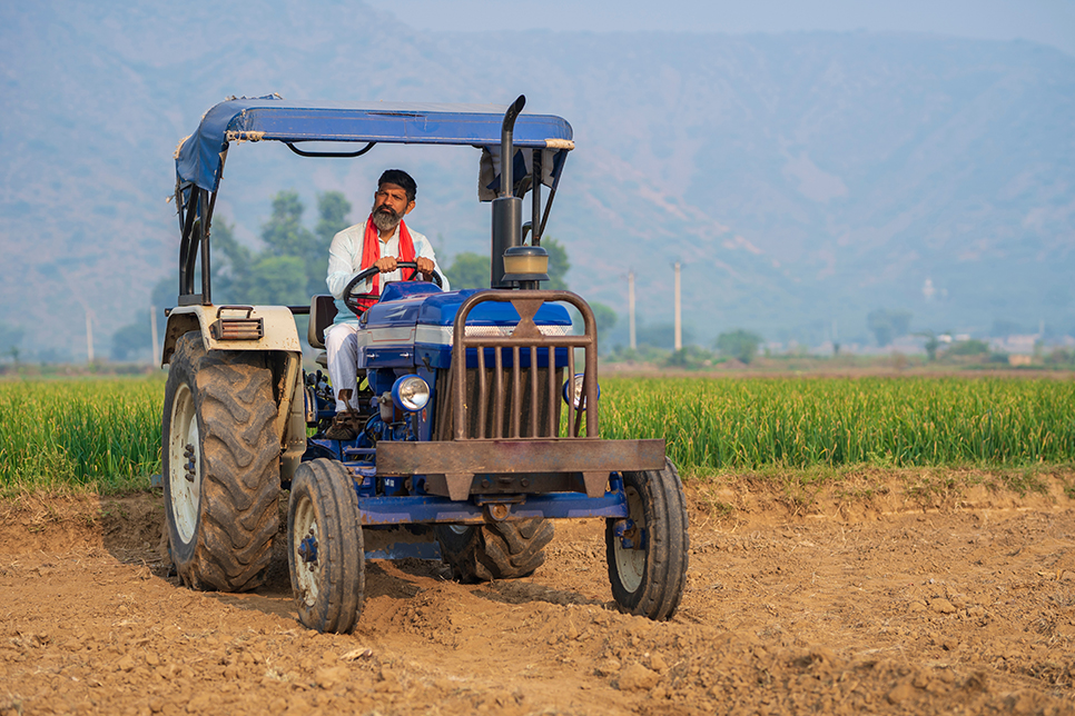 Farmer on a tractor purchased through Tractor Loan from NBFC